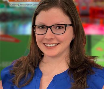 woman with shoulder length brown hair and glasses